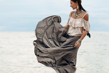 beautiful young woman in elegant dress on the beach