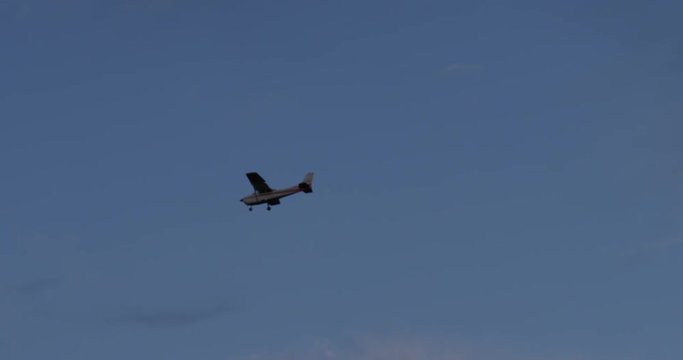 small prop plane flying through clouds in early morning