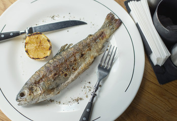 Fish and lemon as a dinner background. Concept and idea of a tasty food