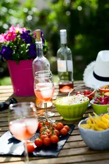 Möbelaufkleber holiday summer brunch party table outdoor in a house backyard with appetizer, glass of rosé wine, fresh drink and organic vegetables © W PRODUCTION