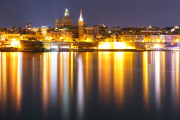 Fototapeta na wymiar Valletta Skyline at night from Sliema with church of Our Lady of Mount Carmel and St. Paul's Anglican Pro-Cathedral, Valletta, Capital city of Malta