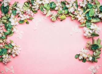 Lovely springtime turquoise blue background with white blossom, top view, frame. Springtime and nature concept