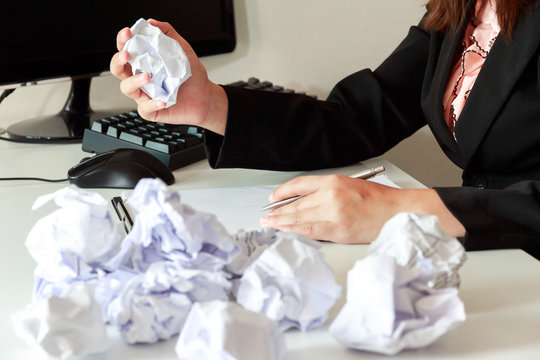 Hands of woman crumple sheets at the desk, mistake contract - failure business concept.