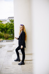 Fototapeta premium Young woman with mobile phone on the street of Vienna