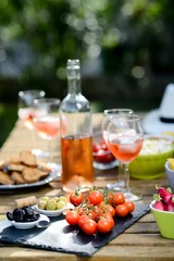 Fotobehang holiday summer brunch party table outdoor in a house backyard with appetizer, glass of rosé wine, fresh drink and organic vegetables © W PRODUCTION