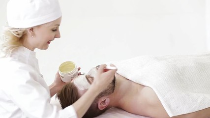 young man on reception at the cosmetician. massage and skin care