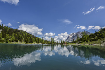 Fototapeta na wymiar Zugspitze reflected in the crystal-clear waters of the turquoise lake Seebensee, Germany's highest mountain, view from Tyrol, Austria, Europe