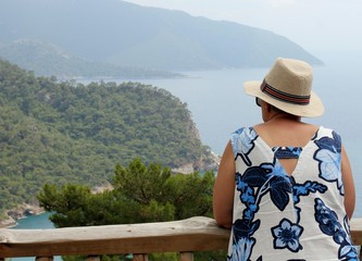Fototapeta na wymiar An english tourist looking out over the beautiful scenic bay at Kabak in Turkey, 2017