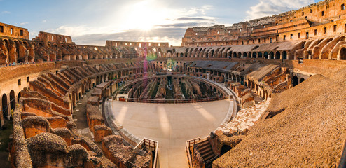 Panoramic view of Roman colosseum interior at sunset