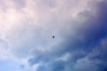 Fototapeta premium aeroplane flying in cloudy sky