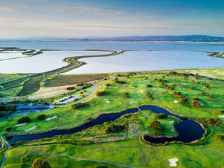Green golf courses and San Francisco Bay in the evening