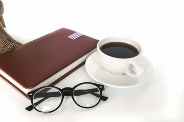 White coffee cup on the desk with books. Concept coffee lover background.