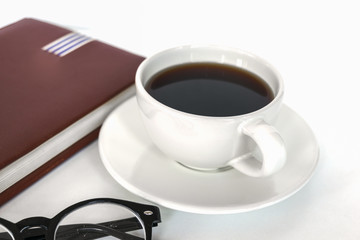 White coffee cup on the desk with books. Concept coffee lover background.