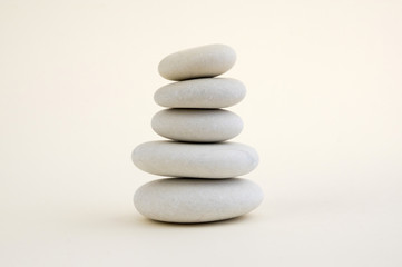 Fototapeta na wymiar Harmony and balance, cairns, simple poise stones on white background, rock zen sculpture, five white pebbles, single tower, simplicity