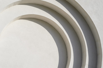 Abstract lines of arches in a white plastered wall. Abstract background with flowing lines....
