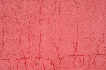 Red plaster wall with cracks. Plaster wall empty background