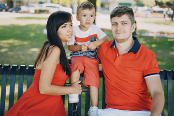beautiful family in red walking down the street and the Park