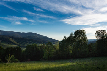 Landscape of mountains disappearing into the distance in the afternoon light