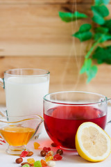 Honey, raspberry jam, milk, towel on rustic background. Candied fruits on a towel. Healthy food. Breakfast. White napkin on the table. The background. Frame

