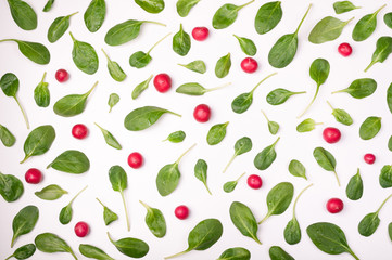 Spinach leaves and radish on white background. Pattern of spinach and vegetables isolated. Creative food concept. Ingredient for salad. Flat lay, top view