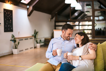 Love couple drinking coffee at home