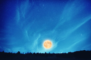Full moon at night on the dark blue sky