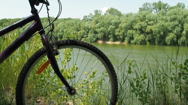 A bicycle on the river close up. Mountain biking in nature.