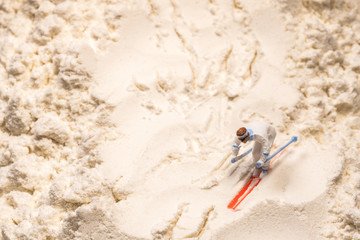 Kleiner Skifahrer trainiert auf einer Abfahrtpiste aus Mehl
