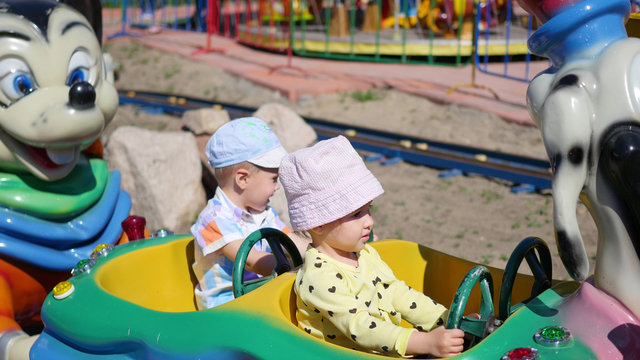 children having fun at an amusement Park.Riding the car