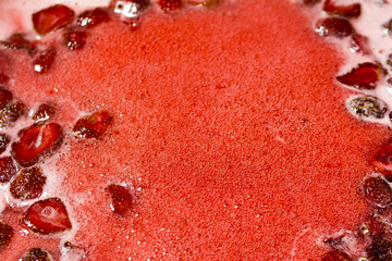 Sticky strawberry jam and wooden spoon