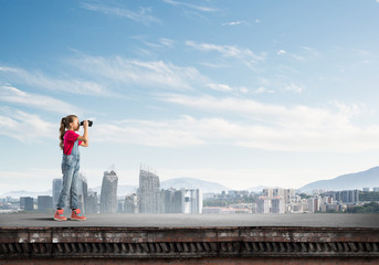 Fototapeta premium Concept of careless happy childhood with girl of school age looking in future