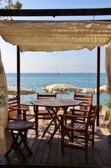 Table set on the beach of Marina di Campo, Elba island, Italy