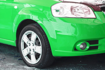 Wing, wheel and car headlight bright color, close-up