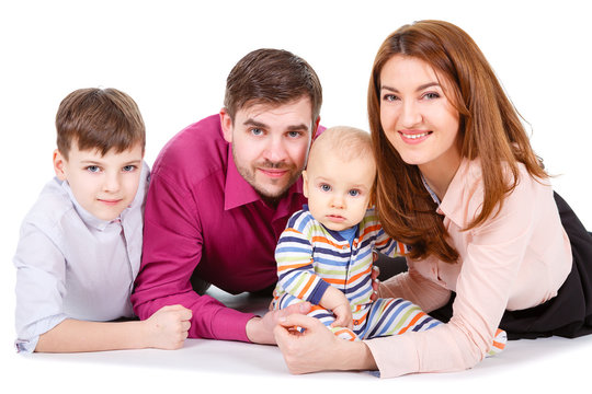 Happy Family with child and baby on a white background isolated, lying on the floor - Concept of happy family