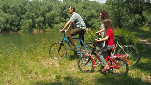 Family on mountain bikes. Active recreation in nature.