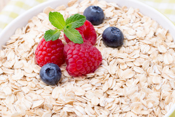 Oatmeal porridge with berries. Raspberries and blueberries.