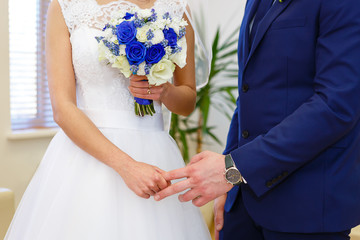 Bride holds the groom by the finger