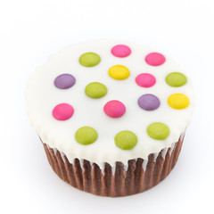 Multiple colorful decorated muffins on a white background.