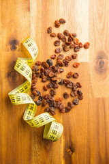 Sweet dried raisins and measuring tape.