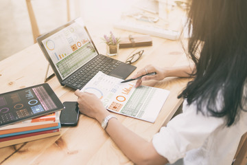 woman working business paperwork on desk,office technology equipment such as laptop tablet  smart...