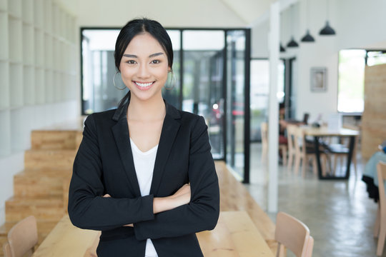 woman smiling and crossed arms,business woman enjoying work,friendly person lifestyle,professional business look for successful concept.