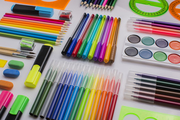 Naklejka premium A lot of stationery on the white surface, diagonal rows, background