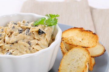 grated cheese and olive spread with crostini