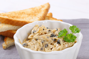 grated cheese and olive spread with toast