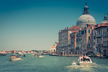 Water taxis are sailing along the Grand Canal in Venice