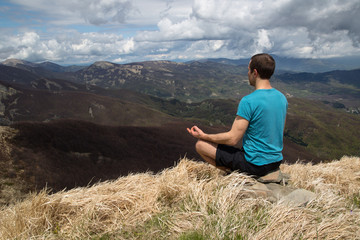 Naklejka premium Meditating on a mountain