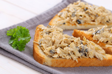 toast with grated cheese and olive spread