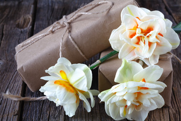 Fototapeta na wymiar white daffodil flowers on old wood table background