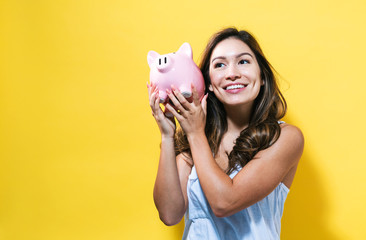 Young woman with a piggy bank