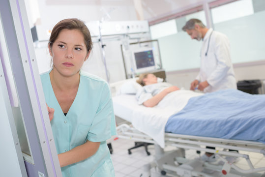 worried nurse looking away and thinking about something